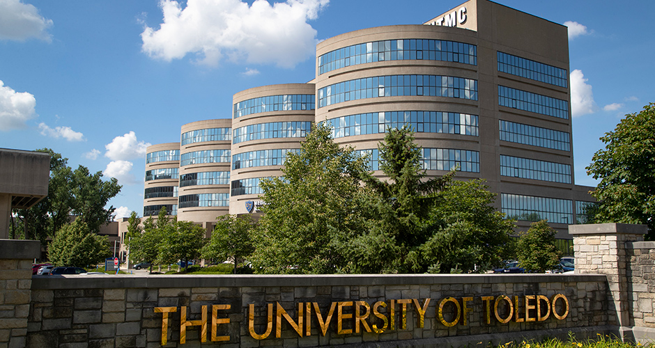 UToledo stone entrance signage with UTMC in the background.