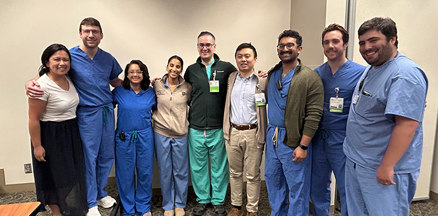 Group photo of residents at a grand rounds.